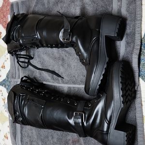 Knee high military lace up boots.